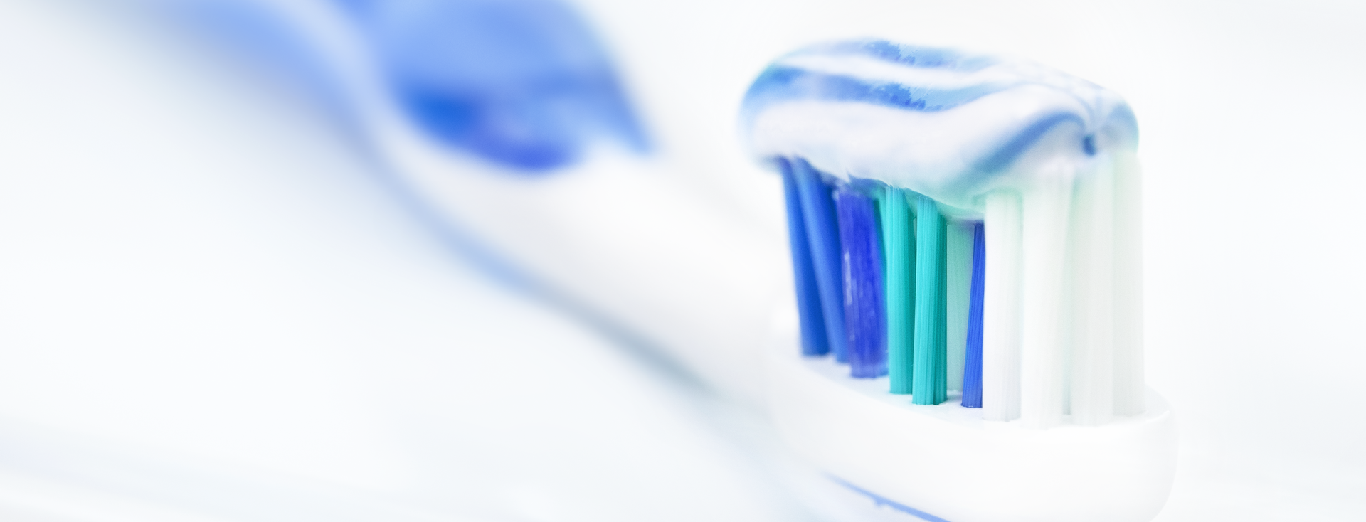 blue and white toothpaste on a blue and white toothbrush blue and white toothpaste on a blue and white toothbrush